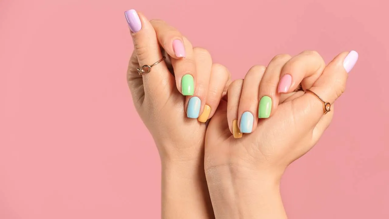 Hands with colorful decorative nail art.