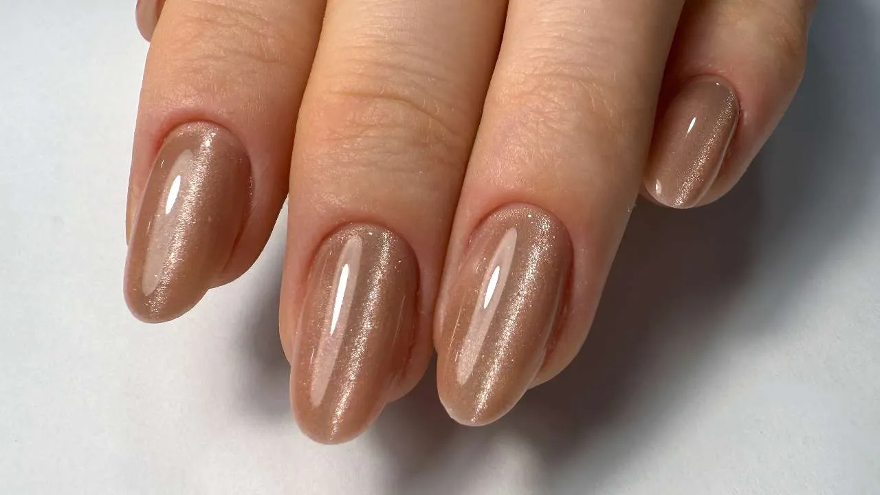 Close-up of nude builder-gel nails.