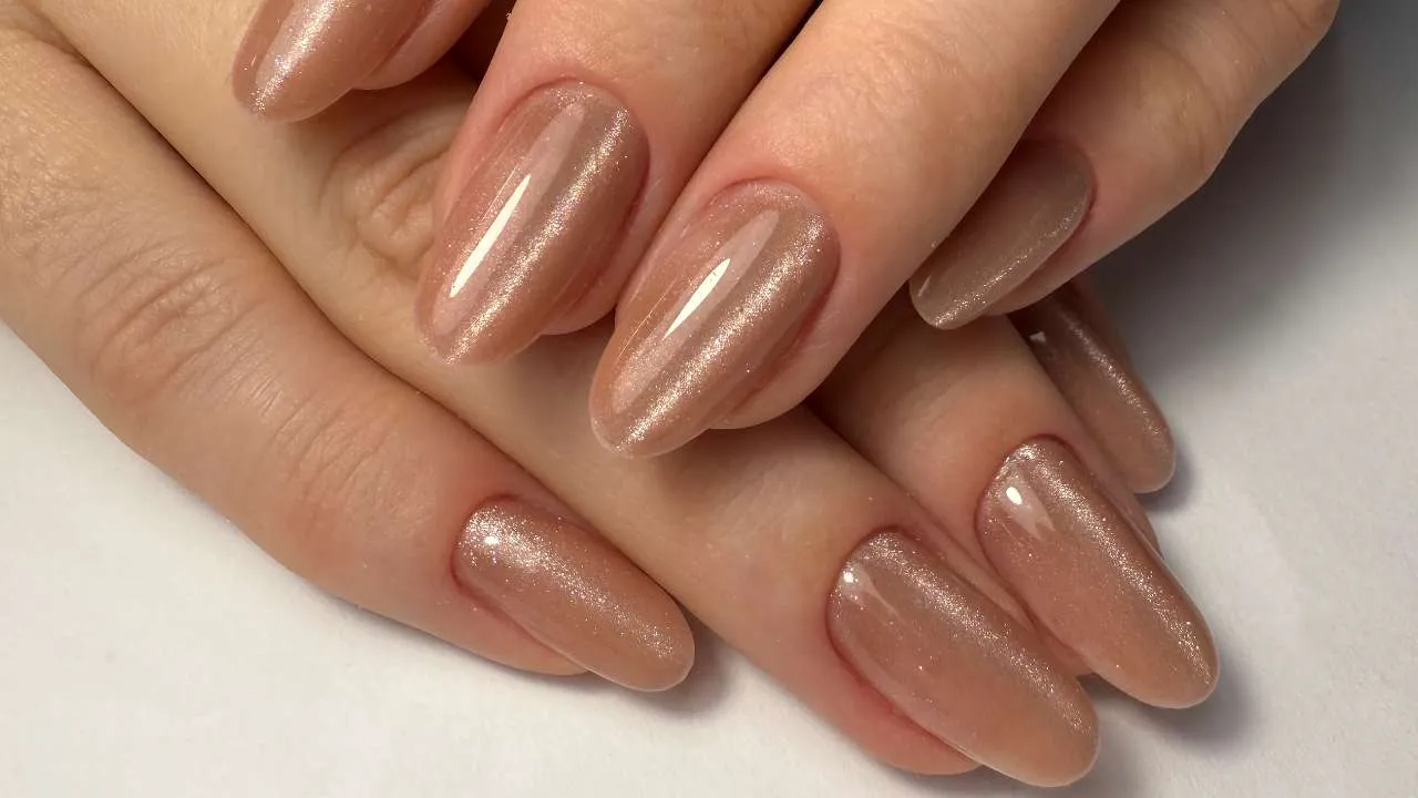 Nude almond-shaped nails with a glossy finish.