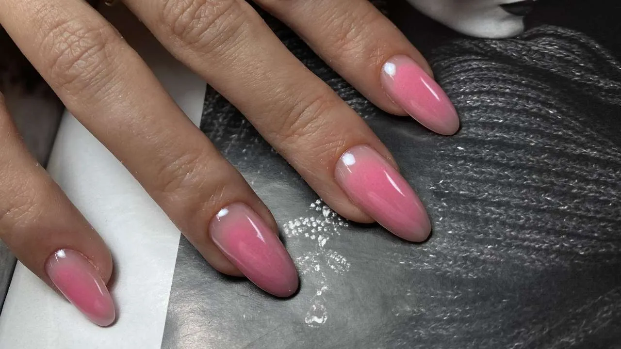 Nail technician working around a client’s cuticle.