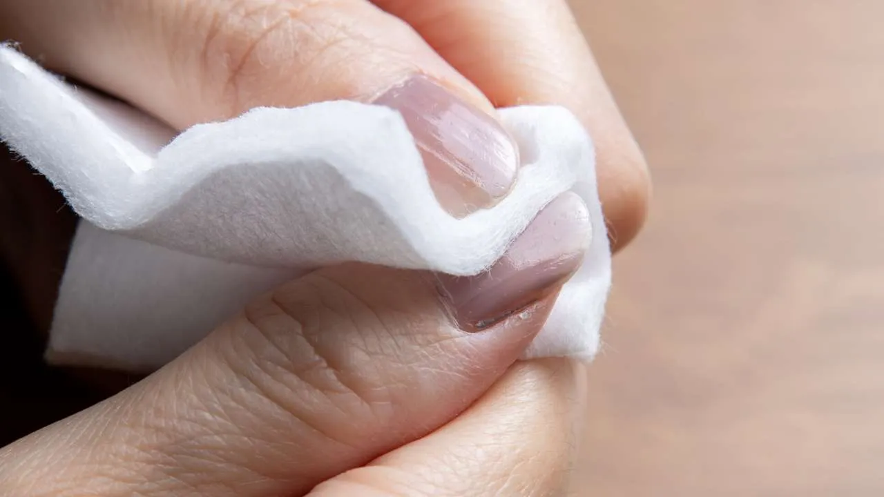Nail technician working on acrylic nails.