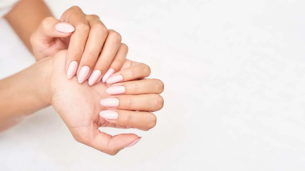 Close-up of a hand with sculpted nail extensions.